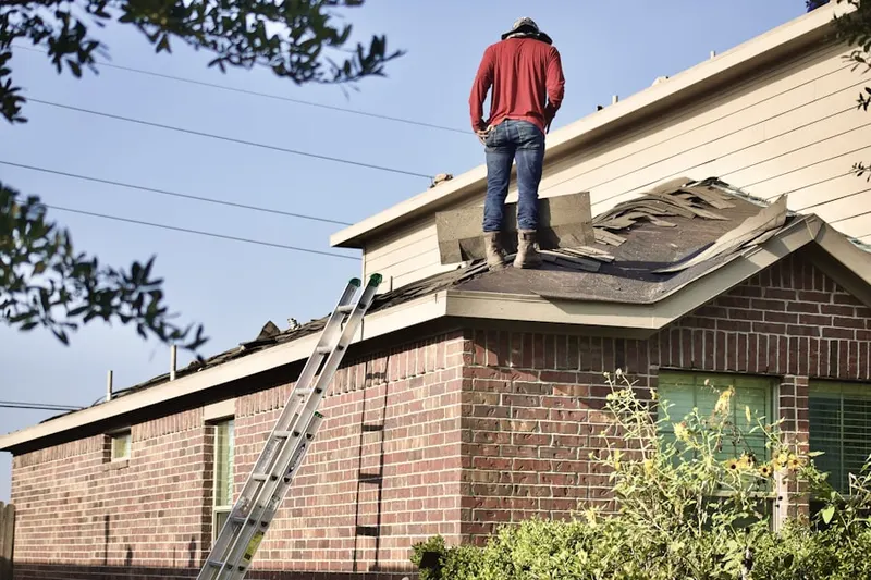Professional roofer working on a residential roof in Potomac